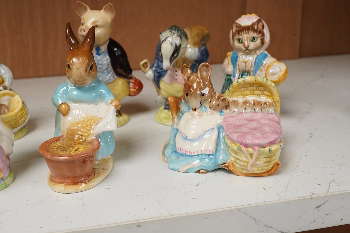 A collection of thirteen Beatrix Potter character figures, stamped with a gold stamp F Warn and Co Ltd, Beswick England, largest 12cm high